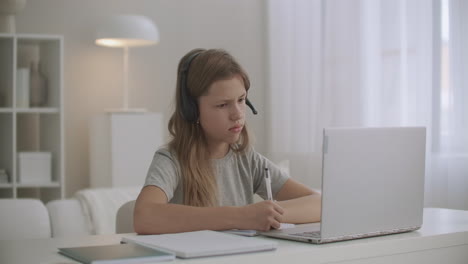 online-lesson-for-schoolgirl-pupil-is-staying-home-using-laptop-and-headphone-for-communicating-with-teacher
